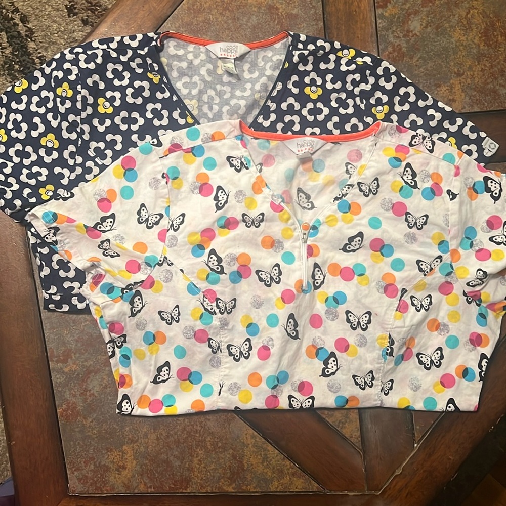 2 scrub tops size medium. Good used condition. No rips or tears. No ink marks.